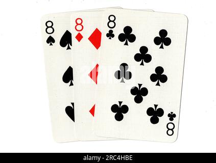 Vintage playing cards showing three eights on a white background. Stock Photo