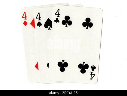 Vintage playing cards showing three fours on a white background. Stock Photo