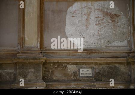 Antique street sign on the weathered stucco wall of Santa Catarina at Piazza Pretoria in Palermo Sicily, Italy. Stock Photo