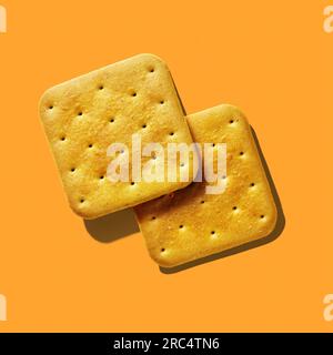 Two crackers close-up on orange background Stock Photo