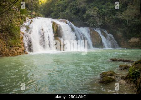 Picturesque scenery of El Chiflon waterfall flowing through rough rocky mountains with green trees in forest at Chiapas Mexico Stock Photo