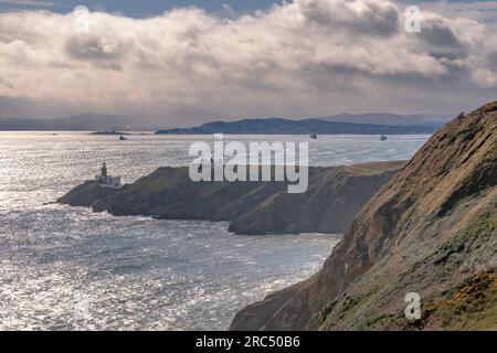 Howth, Ireland,  13th. March, 2023: Howth Lighthouse with ships in Dublin Bay in the background Stock Photo