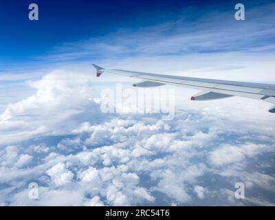 View of clouds and aircraft wing through window of British Airways Airbus A350, Europe Stock Photo