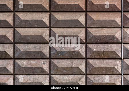 Rectangular bas relief stone tiled blocks close up texture background, textured and stained surface design element Stock Photo