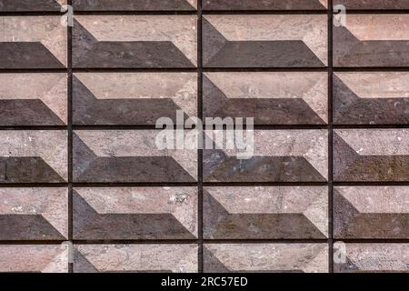 Rectangular bas relief stone tiled blocks close up texture background, textured and stained surface design element Stock Photo