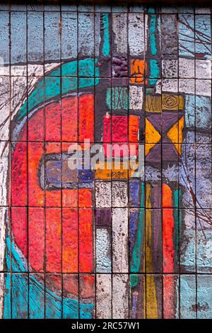 Detail from a building exterior covered with glazed ceramic tiles with colorful abstract shapes Stock Photo