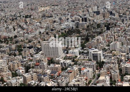 A city is densely populated (many houses and buildings) Amman town. Jordan, middle east from plane Stock Photo