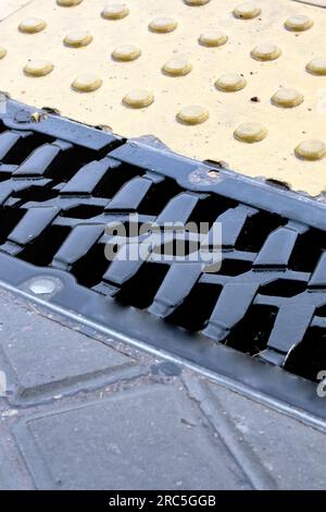 Rain grate on the sidewalk in the rain close up Stock Photo