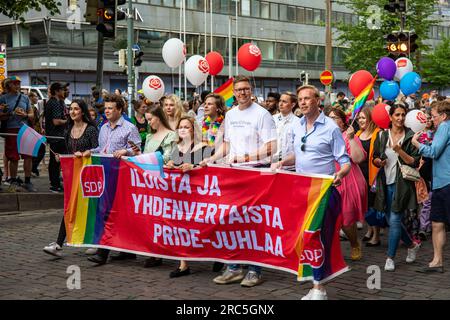 Top politics of Social Democratic Party carrying a SDP banner at Helsinki Pride 2023 parade in Helsinki, Finland Stock Photo