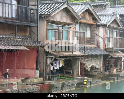 Quaint village of Ine: close-up of the wooden boat houses, funaya, with balconies on the first floor above fishing nets in the boat store below. Stock Photo