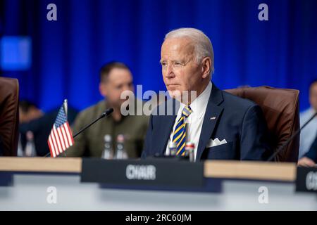 Vilnius, Lithuania. 12th July, 2023. U.S President Joe Biden, listens during meeting of the NATO-Ukraine Council at the NATO Summit, July 12, 2023 in Vilnius, Lithuania. Credit: Adam Schultz/White House Photo/Alamy Live News Stock Photo