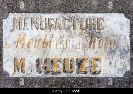 Old faded hand painted wall sign for furniture maker in city center - Tours, Indre-et-Loire (37), France. Stock Photo