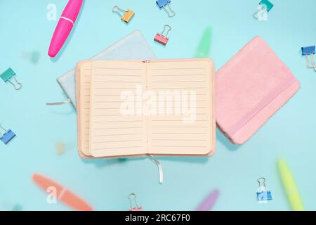 Blank notebook with stationery on blue background Stock Photo