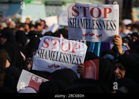 Tehran, Iran. 12th July, 2023. Iranian veiled women hold posters written ''Stop shamelessness'' during a pro-hijab rally to mark Hijab and Chastity Day at Imam Hossein Square in downtown Tehran. (Credit Image: © Rouzbeh Fouladi/ZUMA Press Wire) EDITORIAL USAGE ONLY! Not for Commercial USAGE! Stock Photo