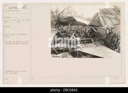 Curtiss JN4 plane No. 2646 is shown here after a forced landing at Kelly Field in San Antonio, Texas. The plane appears to be wrecked as a result of the landing. This photograph was taken on November 23, 1918, and was passed by the M.I.D. censor on December 10, 1918. The image is labeled as 111-SC-28836 in the photo archives. Stock Photo