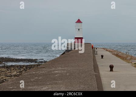 The simple red and white painted  lighthouse at Berwick-on- Tweed the end of of the Pier Stock Photo