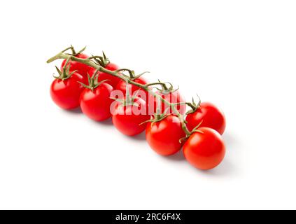 Ripe organic cherry tomatoes on a branch, isolated on white background. Stock Photo