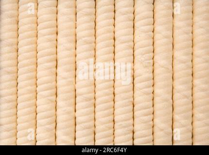 Crispy wafer rolls close-up as a background with space for text. Background of beautifully laid out sweet crispy wafers copy space. Stock Photo