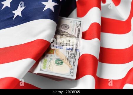 American national flag and hundred dollar bills. The concept of business, finance, economy, international currency. Stock Photo