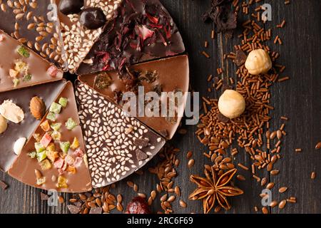 Creative composition chocolate in the shape of a pizza with candied fruits, nuts, dry berries, chocolate pizza and ingredients Stock Photo