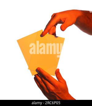 Man holding orange flyers on white background, closeup. Mockup for design Stock Photo