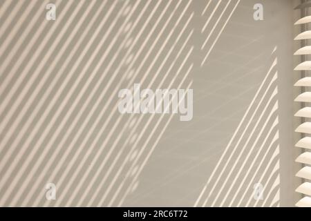 Shadow from window and blinds on beige wall indoors Stock Photo