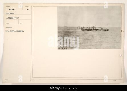 A group of navy sailors are seen conducting military activities during World War One. The image shows them wearing uniforms and participating in an unknown exercise or task. The photo is marked with the serial number 111-SC-43560 and was taken by a photographer from the U.S. Navy Department. Stock Photo