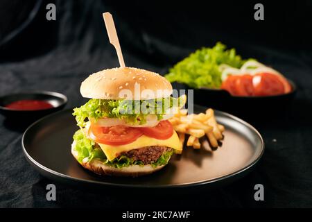 Homemade burger and cheese with fries and icy soft drink Stock Photo