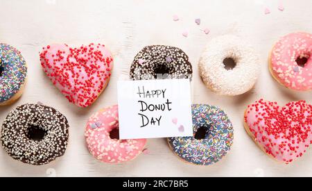 Donuts pattern. Top view of assorted glazed donuts. Colorful donuts with icing. Various colorful glazed doughnuts with sprinkles on a light background Stock Photo