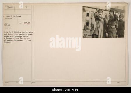 Caption: Sgt. H. Lothers, accompanied by Col. C. H. Hodges, an interpreter, is seen making arrangements with German officer Inspector Ludweg for the utilization of Maximin Barracks in Treves, Germany. The photograph was taken on December 1, 1918, and is numbered 33,188 in the collection. Stock Photo