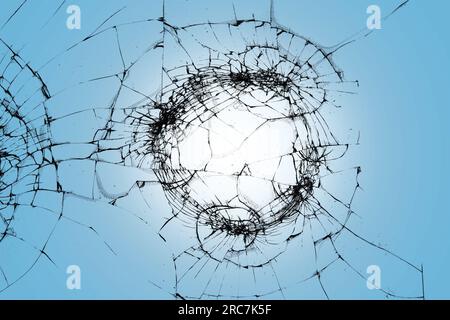Cracks on smartphone screen, texture of broken protective glass on blue background Stock Photo