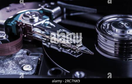 Open hard disk drive with magnetic head closeup. Stock Photo