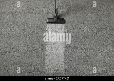 Vacuuming grey carpet. Clean area after using device, top view. Space for text Stock Photo