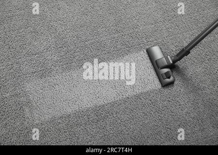 Vacuuming grey carpet, above view. Clean area after using device. Space for text Stock Photo