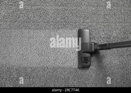 Vacuuming grey carpet. Clean area after using device, top view. Space for text Stock Photo