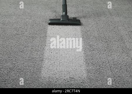 Vacuuming grey carpet. Clean area after using device. Space for text Stock Photo