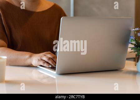 Woman working typing on keyboard laptop computer searching information on keyboard close up. technology digital, online communication, working from ho Stock Photo