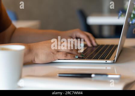 Woman working typing on keyboard laptop computer searching information on keyboard close up. technology digital, online communication, working from ho Stock Photo