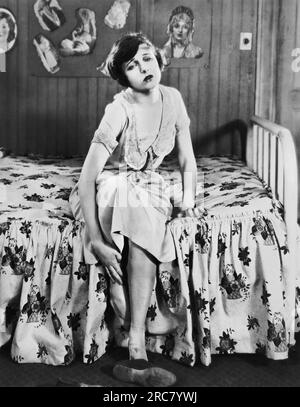 Hollywood, California:  1925 A scene in the silent movie, 'Classified', showing actress Corinne Griffith not feeling so well after a long walk back home. Stock Photo