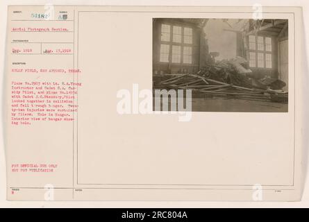 Collision between planes No. 2903 and No. 1493A at Kelly Field, San Antonio, Texas. Lt. S.A. Young and Cadet S.A. Cassidy were in plane No. 2903, while Cadet J.C. Stensary was in plane No. 1493A. The collision caused both planes to fall through a hangar, resulting in 22 injuries. This photograph shows the interior of the hangar with a visible hole. This information is classified. Stock Photo