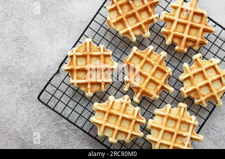 Freshly baked waffles on a baking rack.  Homemade baking. Stock Photo