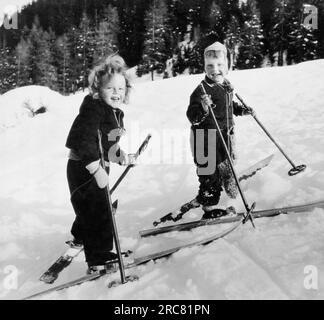 Davos, Switzerland  c.  1928 Two children having fun skiing on the slopes. Stock Photo