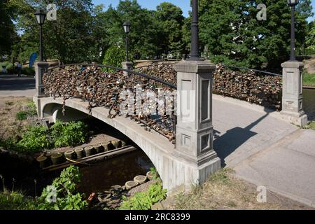 Love padlocks on a stone bridge in a park in the city of Riga, Latvia Stock Photo
