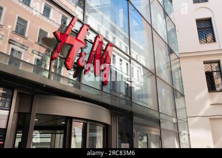 HM store logo in a shopping center in the city of Riga, Latvia. Hennes  Mauritz AB is a Swedish multinational retail clothing company Stock Photo
