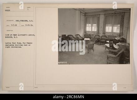 FEMALE EMPLOYEES AT THE PORT ADJUTANT'S OFFICE in Hoboken, N.J., take a break in the ladies' rest room. This space is provided for the women to rest or engage in light recreation. Photographed on June 25, 1919, by Sergeant Stemizer, S.C., the image bears the number 58532. Stock Photo