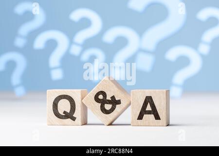 Question and Answers on cubes. question mark symbol on blue background. Problem, solution, confusion counseling. web banner Stock Photo