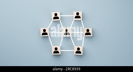 Company hierarchical organizational chart of wooden cubes on blue background. Networking, social media, internet communication line. wooden block with Stock Photo
