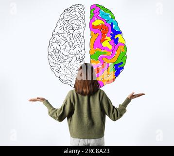 Logic and creativity. Woman and illustration of brain on white background. One bright painted hemisphere and another with different formulas Stock Photo