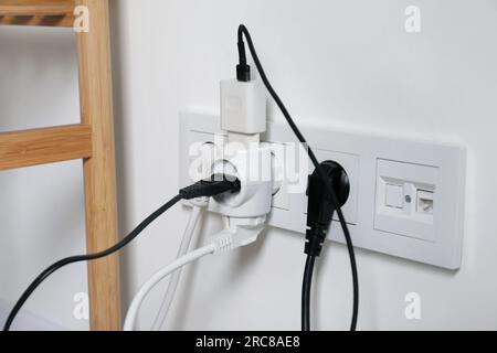 Many different electrical power plugs in sockets indoors Stock Photo