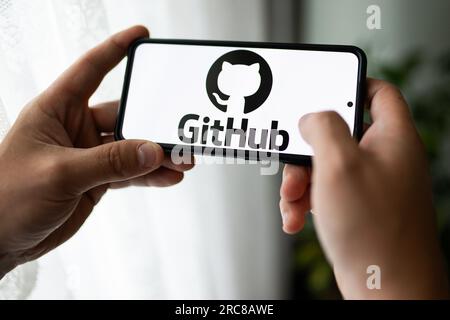 In this photo illustration a GitHub logo seen displayed on a smartphone. Stock Photo